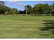 Scenic golf course view showing a well-maintained green with mature trees in the background at 9 Forbes Pl # 310, Dunedin, FL 34698