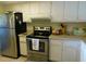 Cozy kitchen with matching appliances, including a stainless steel refrigerator at 9 Forbes Pl # 310, Dunedin, FL 34698