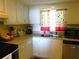 Kitchen space with cabinets and sink under a window letting in plenty of sunlight at 9 Forbes Pl # 310, Dunedin, FL 34698