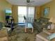 Cozy living room with a view of the outdoors from the sliding glass door at 9 Forbes Pl # 310, Dunedin, FL 34698