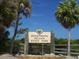 Honeymoon Island State Park sign surrounded by lush palm trees and blue sky at 9 Forbes Pl # 310, Dunedin, FL 34698