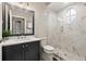 Modern bathroom features a marble countertop, a stylish mirror, and a glass-enclosed shower at 9712 Tree Tops Lake Rd, Tampa, FL 33626