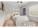 Cozy bedroom with a plush rug, neutral tones, and ample natural light from the window at 9712 Tree Tops Lake Rd, Tampa, FL 33626