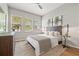 Comfortable bedroom with a decorative headboard, lots of light, and stylish furnishings at 9712 Tree Tops Lake Rd, Tampa, FL 33626