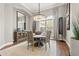 Charming dining room with a round table, chandelier, and natural light at 9712 Tree Tops Lake Rd, Tampa, FL 33626