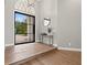 Open foyer with hardwood floors, minimalist console table, and large windows with natural light at 9712 Tree Tops Lake Rd, Tampa, FL 33626