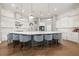 Spacious kitchen with a large island, seating, pendant lighting, white cabinets, and modern appliances at 9712 Tree Tops Lake Rd, Tampa, FL 33626