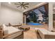 Luxury lanai featuring a spacious seating area and a sparkling pool with sunset view at 9712 Tree Tops Lake Rd, Tampa, FL 33626
