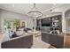 Comfortable living room with large windows, stylish furniture, and built-in shelving at 9712 Tree Tops Lake Rd, Tampa, FL 33626