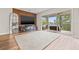 Spacious living room boasts a decorative accent wall, large-screen TV, and balcony access at 9712 Tree Tops Lake Rd, Tampa, FL 33626