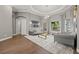 Inviting living room featuring a high tray ceiling, natural light, and comfortable seating at 9712 Tree Tops Lake Rd, Tampa, FL 33626