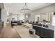 Spacious living room showcasing modern decor and an open layout to the kitchen at 9712 Tree Tops Lake Rd, Tampa, FL 33626