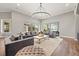 Bright and airy living room with large windows, plush seating, and a modern aesthetic at 9712 Tree Tops Lake Rd, Tampa, FL 33626