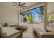 Comfortable outdoor seating area with a view of the screened-in pool and lake at 9712 Tree Tops Lake Rd, Tampa, FL 33626