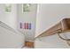 Bright staircase features natural wood handrail and artistic skateboard wall decor at 9712 Tree Tops Lake Rd, Tampa, FL 33626