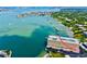 Aerial view showcasing a waterfront condo complex with multiple boat slips on a picturesque bay at 100 Bluff View Dr # 115C, Belleair Bluffs, FL 33770