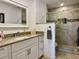 Updated bathroom features granite counters, tiled shower with grab bars, and a glass shower door at 100 Bluff View Dr # 115C, Belleair Bluffs, FL 33770