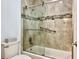 Updated bathroom with a glass-enclosed shower, modern fixtures, and stylish tile work at 100 Bluff View Dr # 115C, Belleair Bluffs, FL 33770
