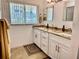 Well-lit bathroom with double vanity, granite countertops, and ample storage space at 100 Bluff View Dr # 115C, Belleair Bluffs, FL 33770