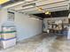 Spacious garage interior view with storage containers and organization system at 100 Bluff View Dr # 115C, Belleair Bluffs, FL 33770