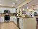 Modern kitchen featuring granite countertops, stainless steel appliances, and stylish backsplash at 100 Bluff View Dr # 115C, Belleair Bluffs, FL 33770