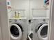 Convenient laundry room features washer and dryer with ample shelving for storage at 100 Bluff View Dr # 115C, Belleair Bluffs, FL 33770