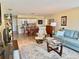 Open-concept living area flowing into the dining room and kitchen, perfect for modern living and entertaining at 100 Bluff View Dr # 115C, Belleair Bluffs, FL 33770