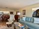 Comfortable living area with a plush sofa, elegant decor, and open view to the dining area at 100 Bluff View Dr # 115C, Belleair Bluffs, FL 33770
