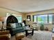 Bright living room with comfortable seating, stylish decor, and scenic views from the expansive windows at 100 Bluff View Dr # 115C, Belleair Bluffs, FL 33770