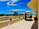 Sunny patio is a great place to relax, with outdoor furniture and views of palm trees at 100 Bluff View Dr # 115C, Belleair Bluffs, FL 33770