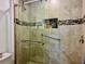 Tiled shower features grab bars and a convenient in-set shelf for toiletries at 100 Bluff View Dr # 115C, Belleair Bluffs, FL 33770