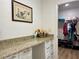 Convenient dressing area with granite counters, a large mirror, and easy access to a walk-in closet at 100 Bluff View Dr # 115C, Belleair Bluffs, FL 33770