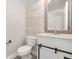 Charming half bath with wood accent wall and modern vanity at 10966 Winter Crest Dr, Riverview, FL 33569