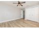 Bedroom features wood floors, a ceiling fan, and closet storage at 10966 Winter Crest Dr, Riverview, FL 33569