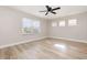 Spacious bedroom with hardwood floors and lots of natural light from three windows at 10966 Winter Crest Dr, Riverview, FL 33569