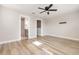Bright bedroom with wood floors, ceiling fan, and ensuite bathroom at 10966 Winter Crest Dr, Riverview, FL 33569