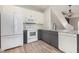 Modern kitchen with white and gray cabinets, stainless steel appliances, and hardwood floors at 10966 Winter Crest Dr, Riverview, FL 33569