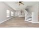 Bright living room with hardwood floors, two windows, and an open staircase at 10966 Winter Crest Dr, Riverview, FL 33569