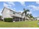 Townhouse rear with a screened patio and lush lawn next to a lake at 10966 Winter Crest Dr, Riverview, FL 33569