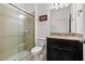 Bathroom features dark wood cabinets, granite counters, and a glass-enclosed shower at 11434 Leland Groves Dr, Riverview, FL 33579