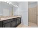 Bathroom features a double vanity with granite countertop, framed mirror and walk-in shower at 11434 Leland Groves Dr, Riverview, FL 33579