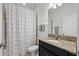 Bathroom with a vanity, granite counters, patterned shower curtain, and tiled floors at 11434 Leland Groves Dr, Riverview, FL 33579