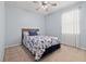 Light-filled bedroom with a nautical-themed bedspread, ceiling fan, and pale blue walls at 11434 Leland Groves Dr, Riverview, FL 33579