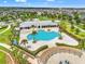 Aerial view of community pool and lounging area with palm trees at 11434 Leland Groves Dr, Riverview, FL 33579