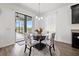 Cozy dining area with a glass-top table, patterned chairs, and a view of the screened patio at 11434 Leland Groves Dr, Riverview, FL 33579