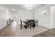 Dining room featuring a dining table with chairs, modern chandelier, and hardwood floors at 11434 Leland Groves Dr, Riverview, FL 33579