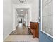 Hallway leading to the main living area with neutral walls and hardwood flooring at 11434 Leland Groves Dr, Riverview, FL 33579