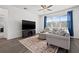Cozy living area with a dark hardwood floors, large TV, and light-colored sofa at 11434 Leland Groves Dr, Riverview, FL 33579