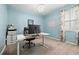 Bright office with modern desk, chandelier lighting, and a large window at 11434 Leland Groves Dr, Riverview, FL 33579