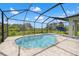 Screened-in pool area featuring an in-ground pool, spa, and an umbrella for sunbathing at 11434 Leland Groves Dr, Riverview, FL 33579